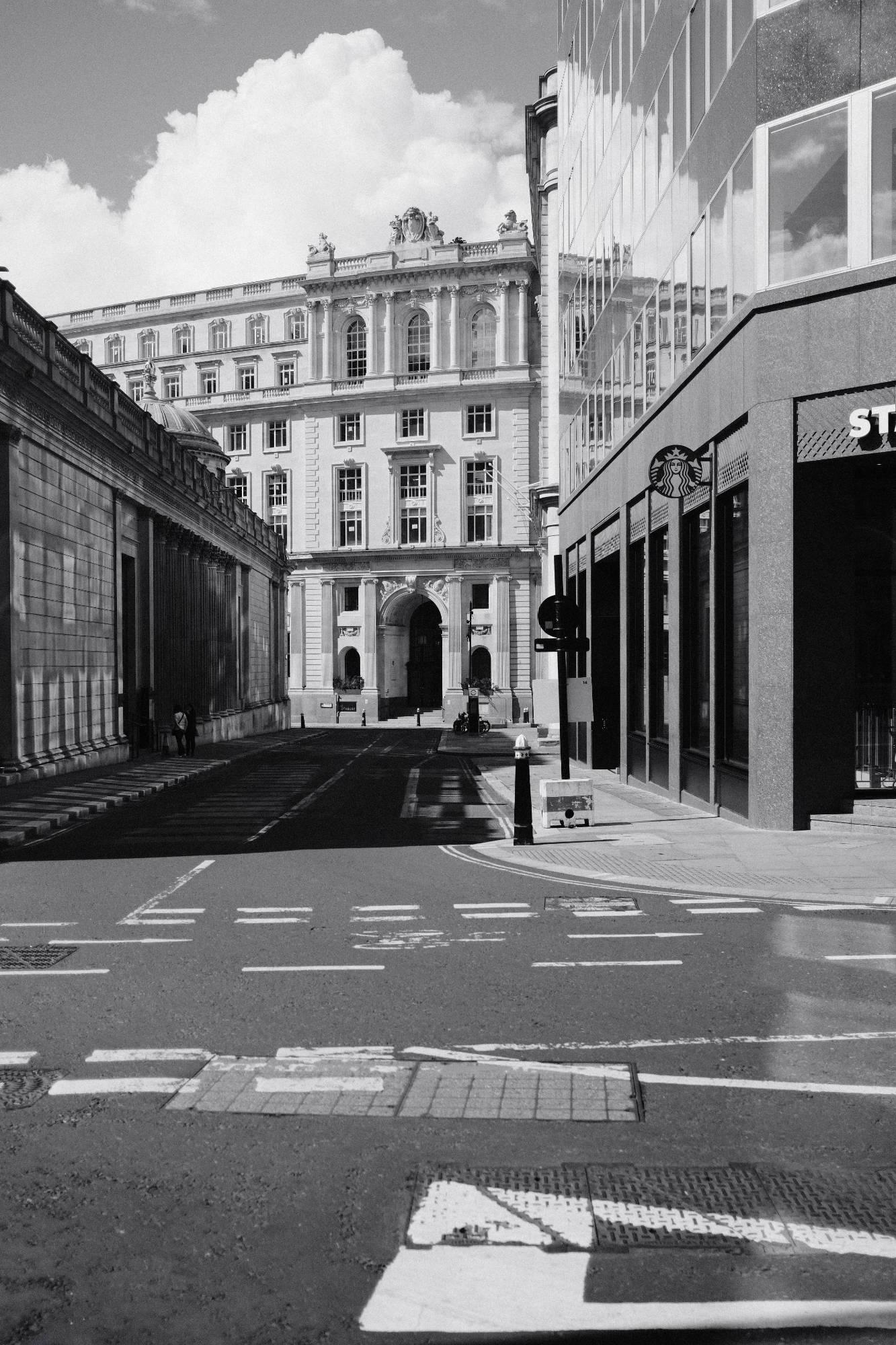 corner of Threadneedle Street in London, with Starbucks and Bank of England Museum in view, grayscale